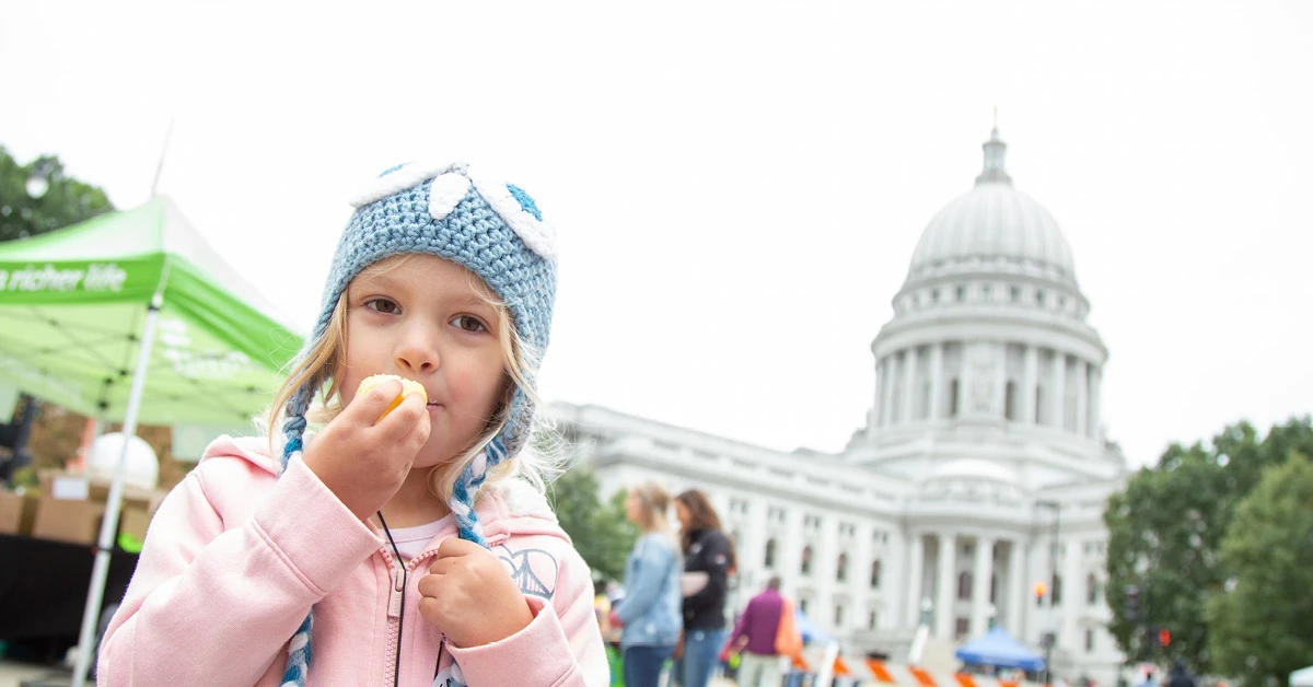 Young kid eating by the capital 