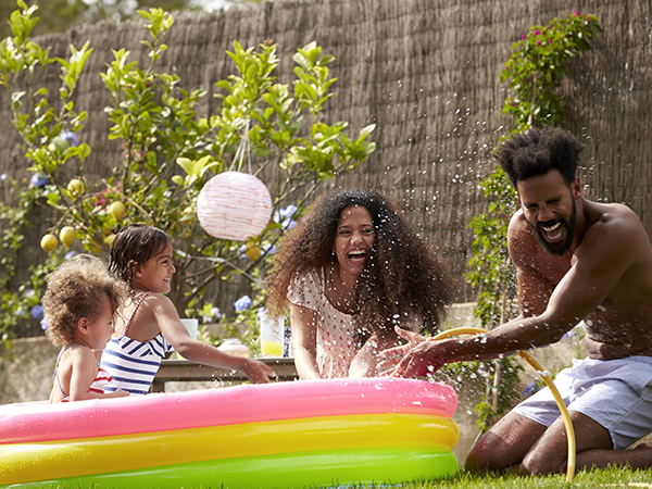 Family playing together in kid's pool