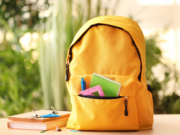 Yellow backpack with school supplies